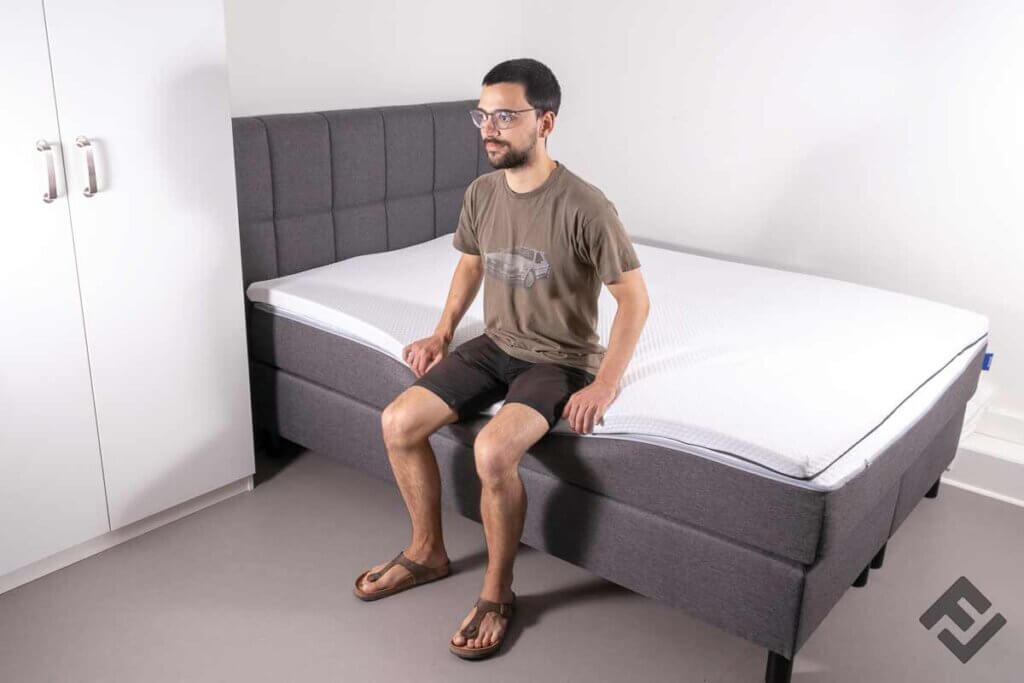 man sitting on bed